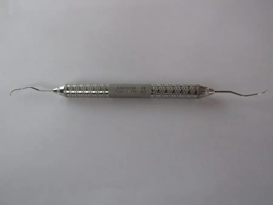 A steel dental explorer, the hooked probe used to check teeth